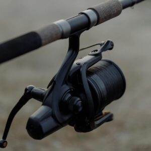 High-quality image of a fishing reel on a rod, perfect for outdoor enthusiasts.